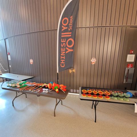 Chinese Yo-yo School feather flag and yo-yo tables at an indoor event