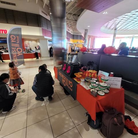 Chinese Yo-yo School booth inside a shopping mall with children trying yo-yos